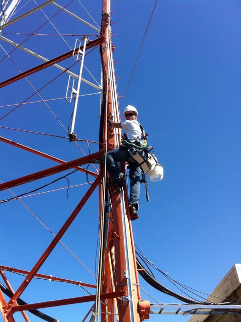 A maintenance man climbing a tower