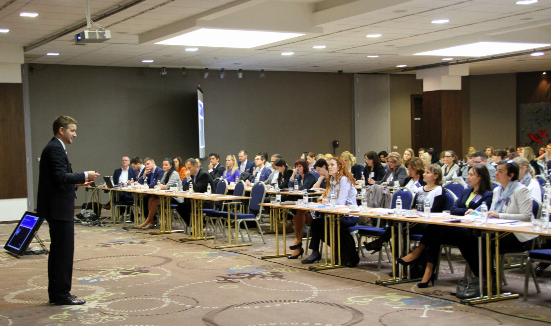 A presenter giving a speech at a conference