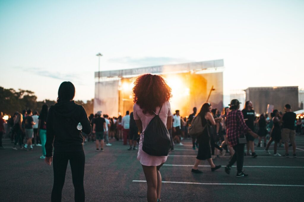 A group of young concert-goers attending an outdoor concert