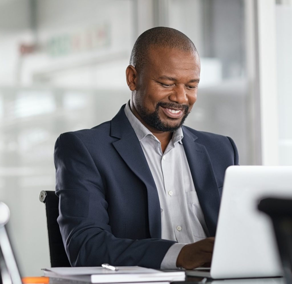 A business man sitting in his office on his desktop computer