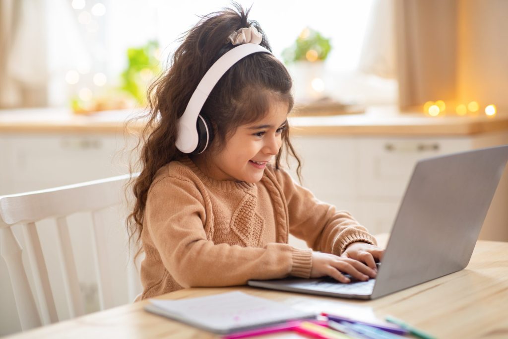 A young girl on her laptop at home