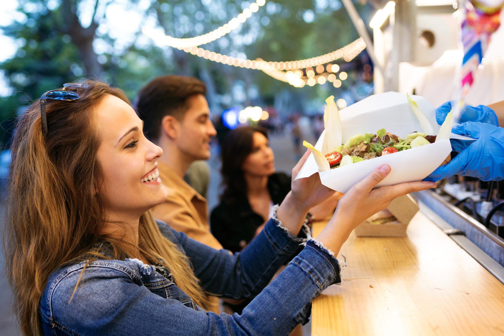 A woman ordering food from a food truck